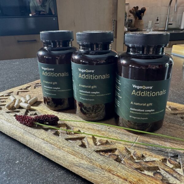 Three supplement bottles on wooden tray