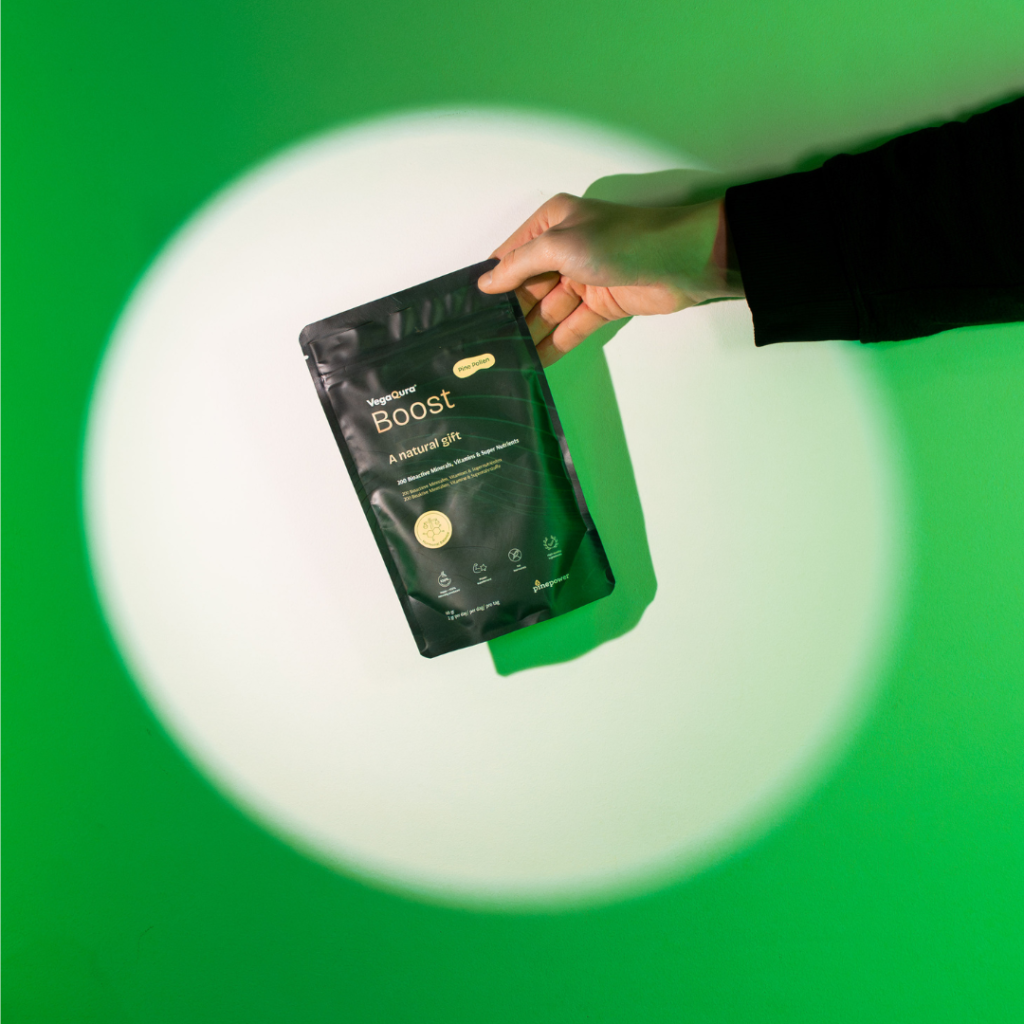 Hand holding a green product package
